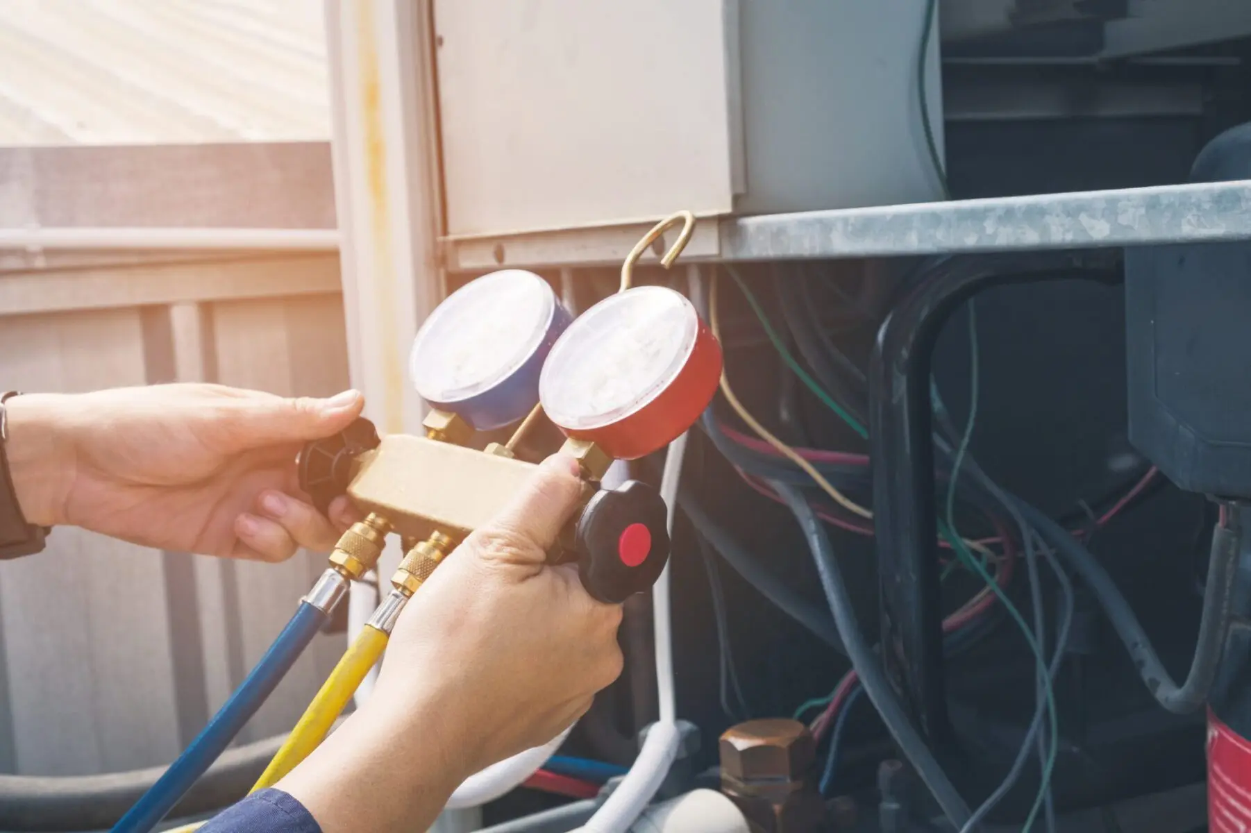 Why Is My AC Unit Fan Outside Not Spinning? - Day & Night Air Conditioning, Furnace, & Plumbing Technician is checking air conditioner