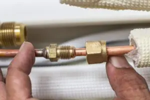 Day & Night Air showing frozen pipes on an air conditioner