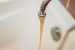Day & Night Plumbing showing brown water coming out of a faucet in Phoenix, AZ