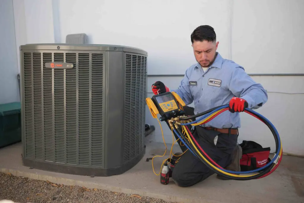 Team Member Fixing an Air Conditioner