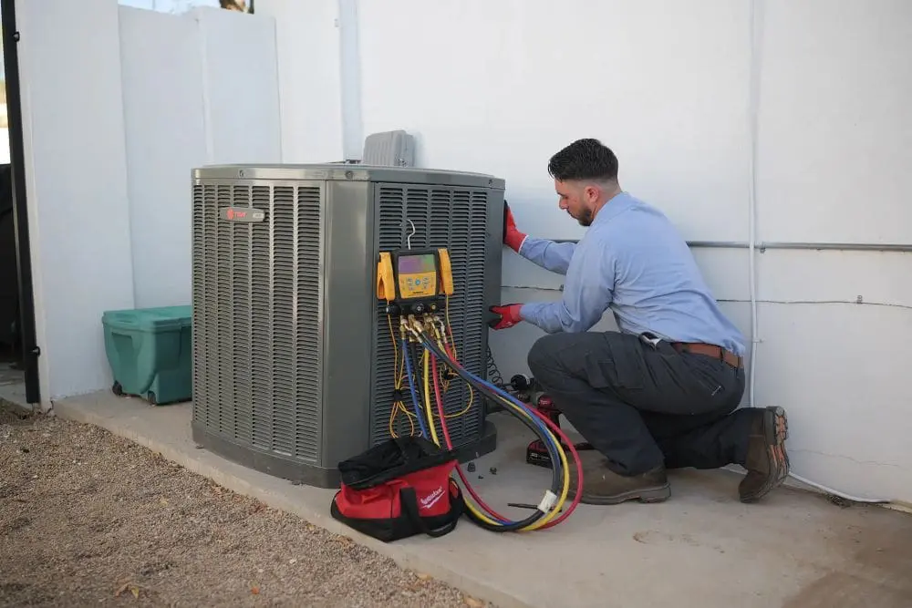 Commercial air conditioning unit in Phoenix, Arizona with diagnostic gauges and hoses connected for maintenance service. Day & Night Air Conditioning, Heating, and Plumbing provides commercial AC maintenance in Phoenix, helping businesses keep cooling systems working with routine inspections and service. The setup includes tools, hoses, and testing equipment used to check refrigerant levels, system pressure, and overall performance. Businesses in Phoenix can contact Day & Night Air Conditioning, Heating, and Plumbing at (602) 584-7758 for commercial AC maintenance, repair, and installation services.