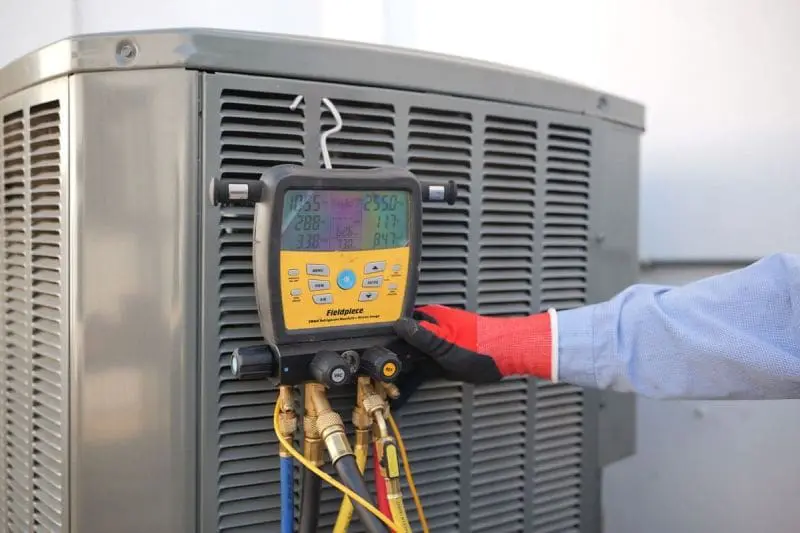 Commercial air conditioning unit in Phoenix, Arizona with a digital HVAC diagnostic gauge connected by multiple hoses for system testing. Day & Night Air Conditioning, Heating, and Plumbing provides commercial AC repair in Phoenix AZ using advanced tools to check refrigerant levels, pressure readings, and system performance. The setup reflects real repair work where technicians inspect cooling systems and identify faults in commercial HVAC units. Businesses in Phoenix can contact Day & Night Air Conditioning, Heating, and Plumbing at (602) 584-7758 for commercial AC repair services, installation support, and ongoing maintenance.