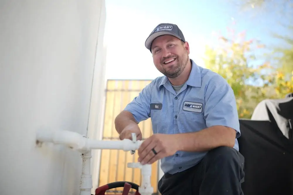 An exterior plumbing system in Phoenix, Arizona with exposed pipes and shut-off valves connected to a building wall. Day & Night Air Conditioning, Heating, and Plumbing provides commercial plumbing in Phoenix AZ, handling pipe repairs, valve replacements, and system maintenance for business properties. The visible setup reflects real plumbing service work including pipe adjustments, connection checks, and water flow control. Businesses in Phoenix can contact Day & Night Air Conditioning, Heating, and Plumbing at (602) 584-7758 for commercial plumbing services including repairs, installation, and maintenance.