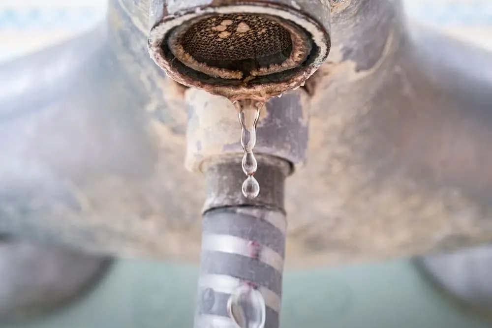 Bathroom faucet old dirty in plaque and rust, dirty water concept