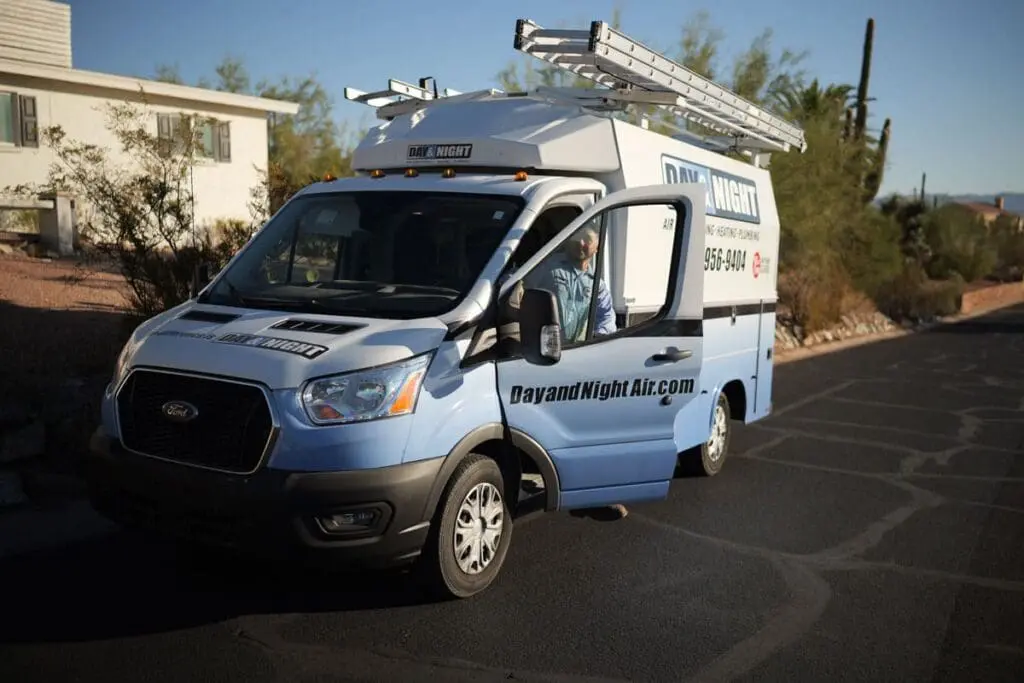 A Day & Night Air Conditioning, Heating and Plumbing service vehicle arrives for Emergency AC Repair in Chandler, AZ at a residential property. The image shows a fully equipped HVAC service van parked in a neighborhood setting with a technician preparing to respond to an urgent air conditioning problem. Emergency AC repair service helps Chandler homeowners restore cooling quickly when systems fail during periods of extreme Arizona heat. Day & Night Air Conditioning, Heating and Plumbing provides emergency air conditioner repair, diagnostics, and cooling services throughout Chandler, Arizona.