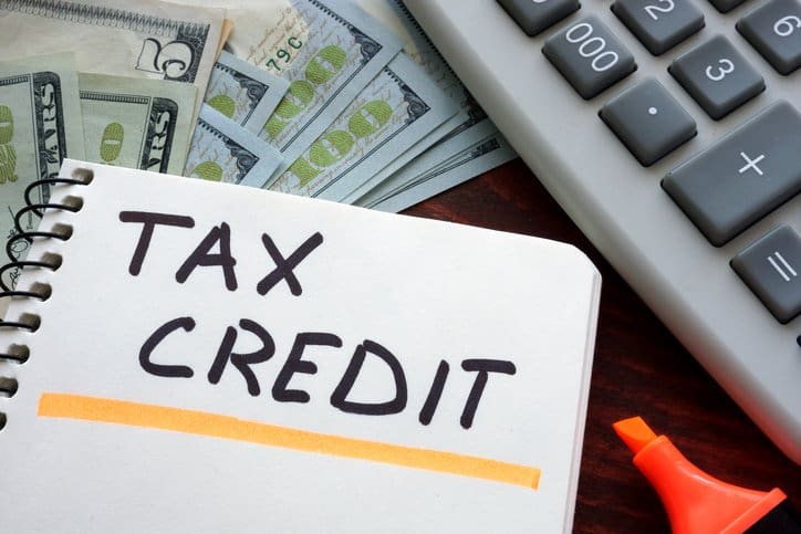 Notebook with tax credit sign on a table. Business concept.