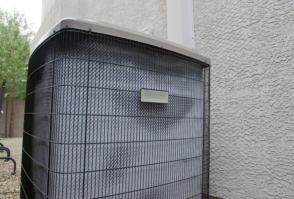 Air conditioning unit in the side yard of a home alongside wall