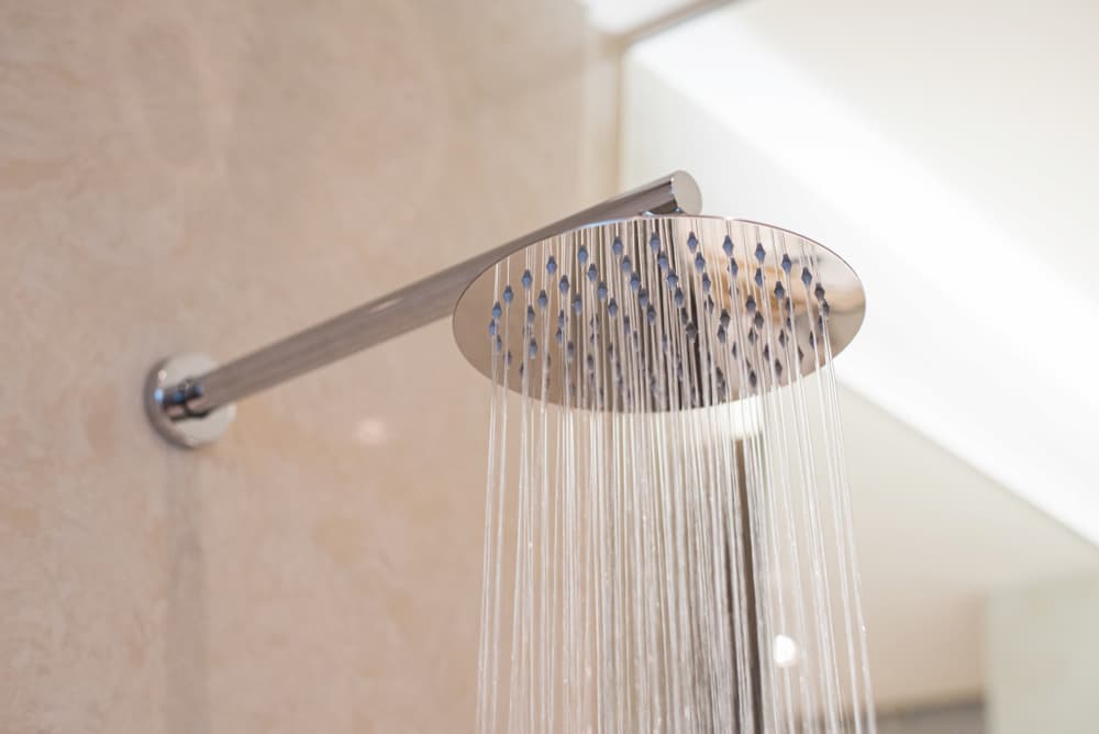 close up on shower head with water coming out
